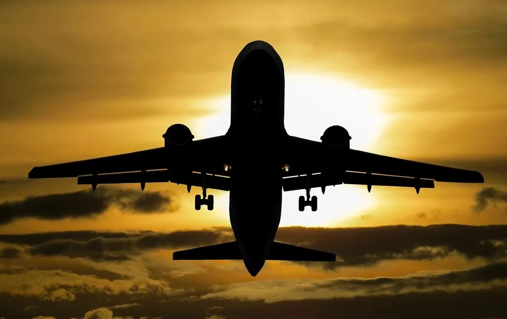 Aircraft taking off at sunset